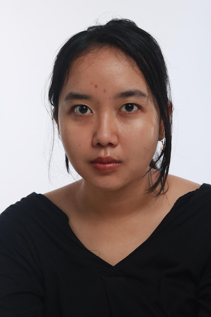 Young Asian woman with no make up on white background