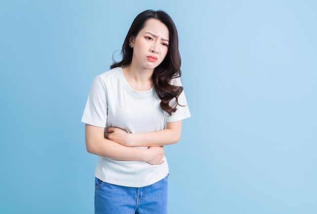 Young Asian woman with stomachachexA