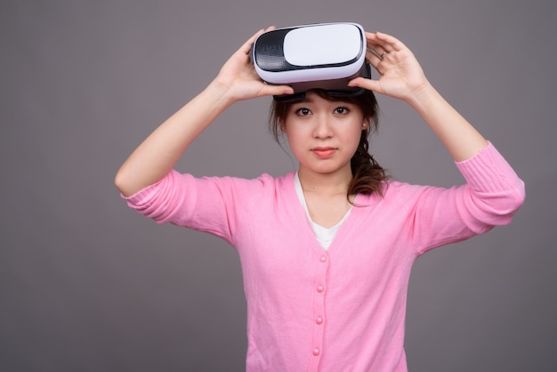 Young Asian woman with virtual reality VR glasses