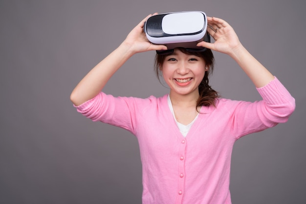 Young Asian woman with virtual reality VR glasses