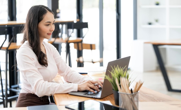 Young asian woman working on laptop computer at coworkspace