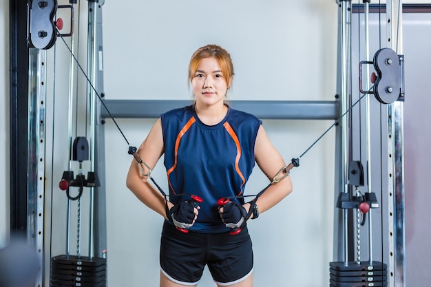 Young Asian woman working out and doing fitness training at a local gym