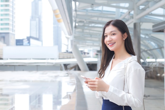 Young Asian working woman is going out to office to see client.