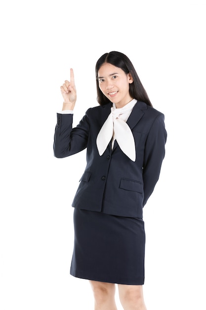 Young Asian young girl  thinking and pointing  upwards while smiling .