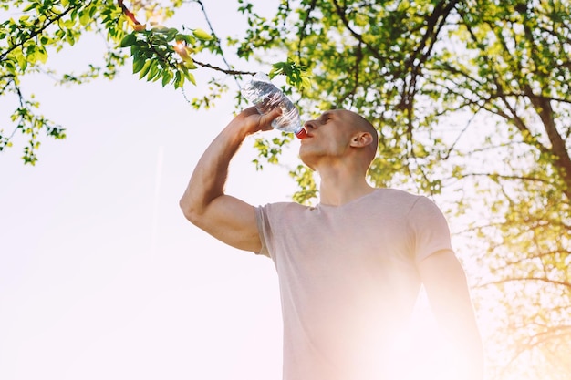 Young athlete is refreshing himself with water sport and healthy lifestyle