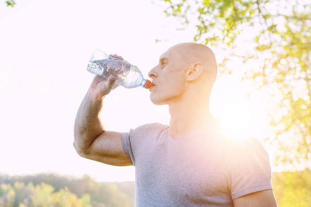 Young athlete is refreshing himself with water sport and healthy lifestyle