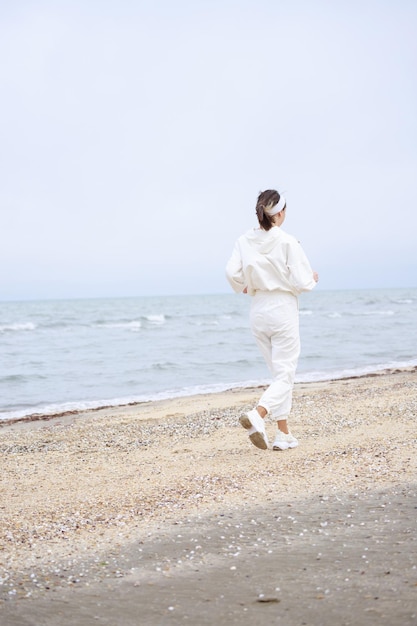 Young athlete running on the beach in the morning High quality photo