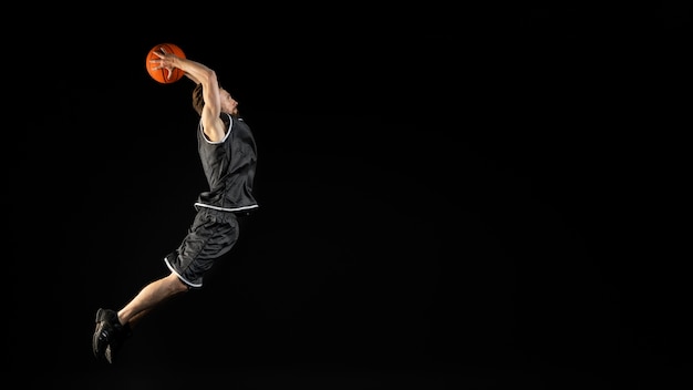 Young athletic man holding a basketball