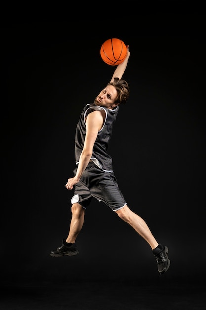 Young athletic man holding a basketball