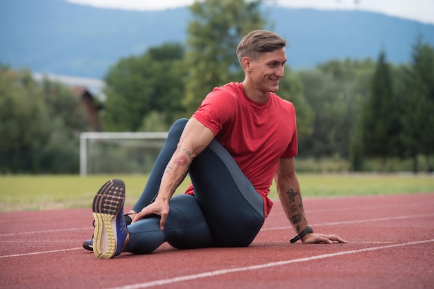 Young Athletic Man Stretching Before Running Exercise