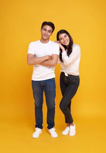 Young attractive Asian couple man and woman wearing white t shirt and jeans Teasing each other