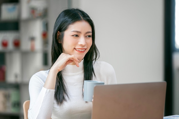 Young attractive businesswoman thinking at office sitting and looking away