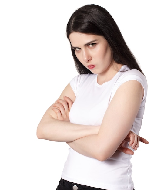 Young attractive caucasian long black haired brunette woman in white t shirt, offended woman concept idea