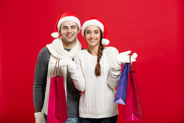 Young attractive couple holding shopping bag enjoy shopping and celebrating in Christmas day.