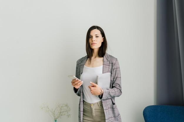 Young attractive european woman to see a smart phone relaxing at home