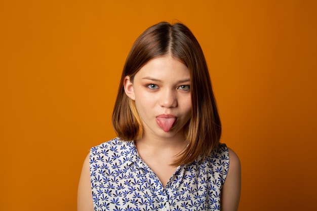 young attractive female shows tongue