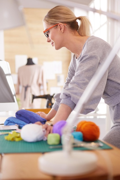 Young attractive females fashion designers leaning on office desk working with a laptop