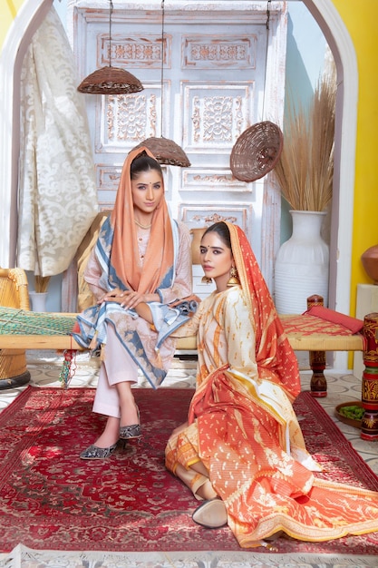 Young Attractive Girls Wearing Traditional Dress on Traditional Theme Background