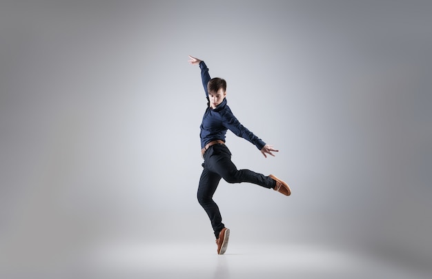 Young attractive man dancing on white background