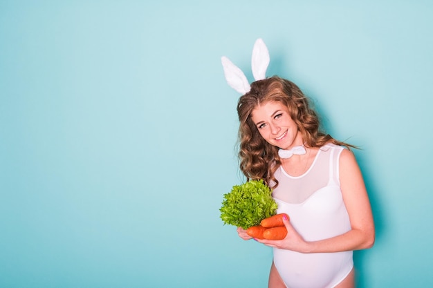 Young attractive pregnant girl in a bunny suit