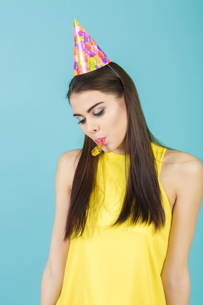 Young attractive smiling woman with a birthday hat