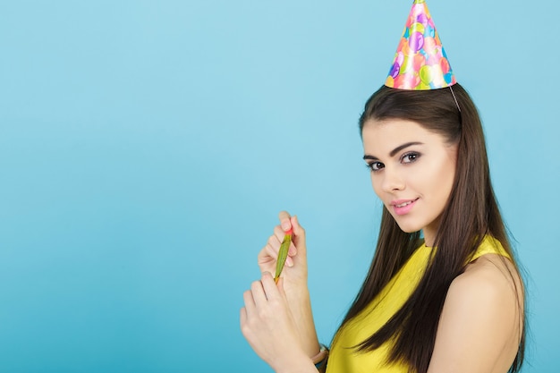 Young attractive smiling woman with a birthday hat