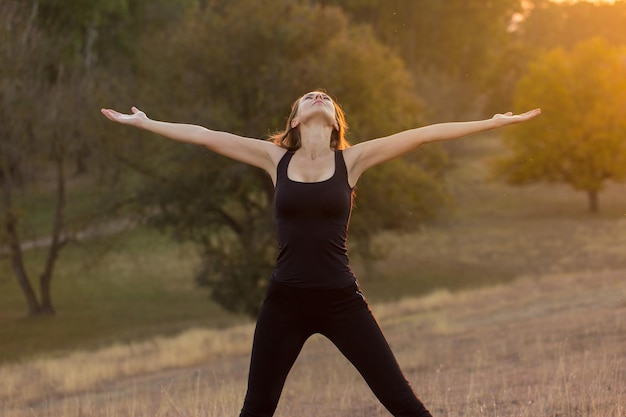 Young attractive woman doing exercise working out outdoors