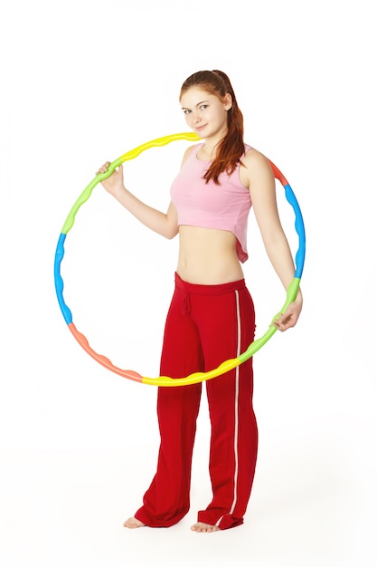 Young attractive woman fitness instructor holding hula hoop