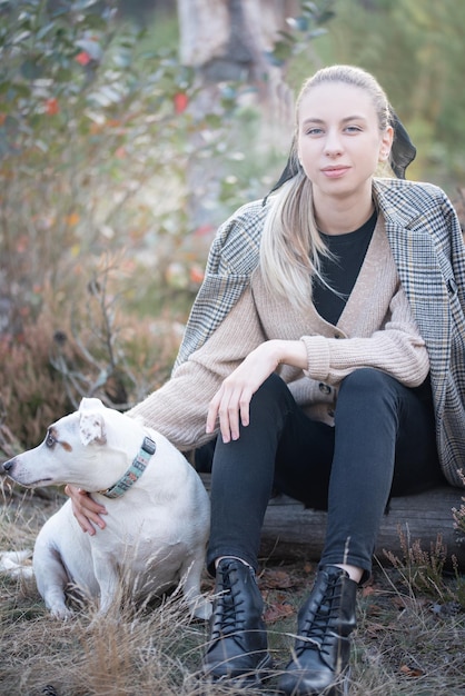 Young attractive woman playing with dog