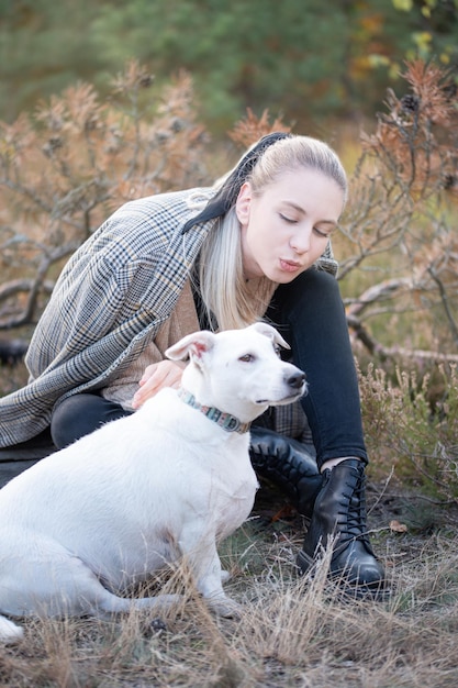 Young attractive woman playing with dog