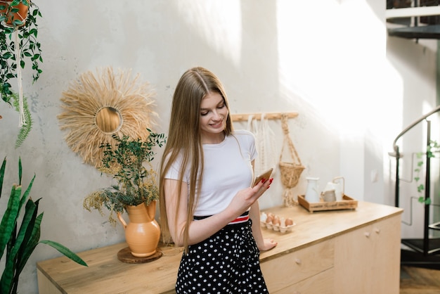 Young attractive woman relaxing on white sofa at window at home