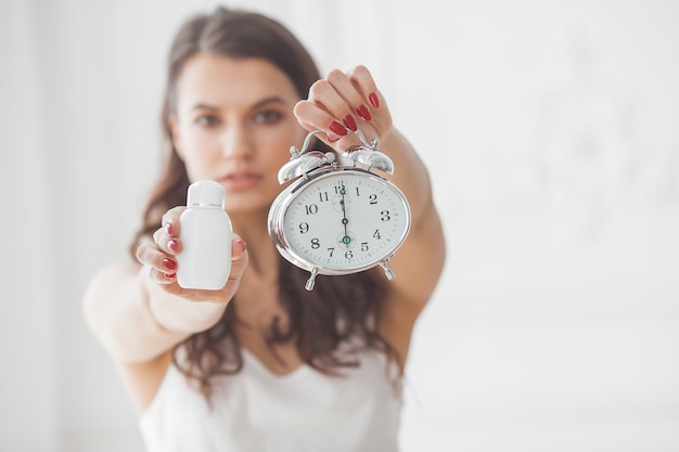 Young attractive woman taking pills at right time