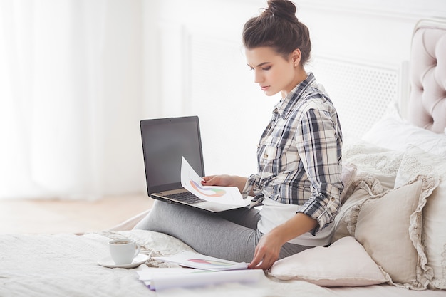 Young attractive woman working home at the laptop