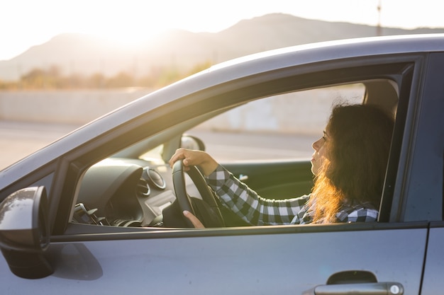 Young attractive young woman behind the wheel.