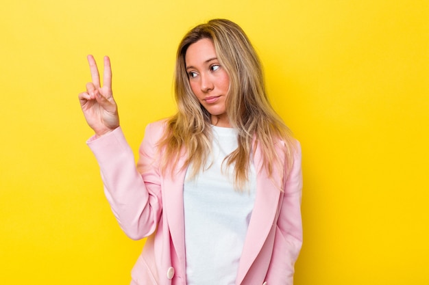 Young australian woman isolated joyful and carefree showing a peace symbol with fingers.