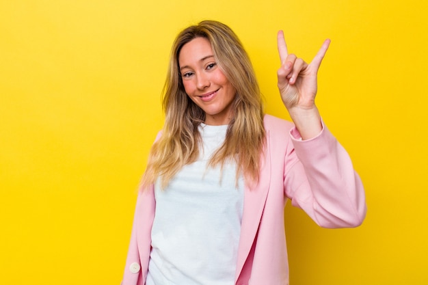 Young australian woman isolated showing a horns gesture as a revolution concept.