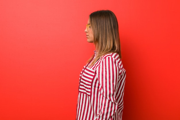 Young authentic charismatic real people woman against a wall gazing left