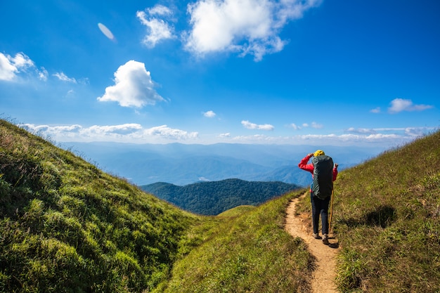 Young backpacking woman hiking on mountains. Doi Mon Chong, Chiangmai, Thailand.