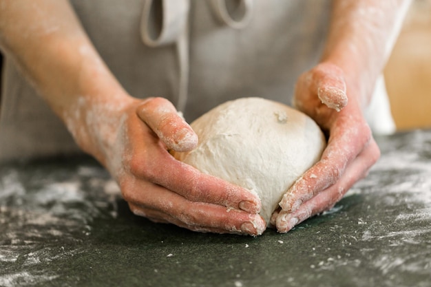 Young baker preparing artisan sourdough bread.