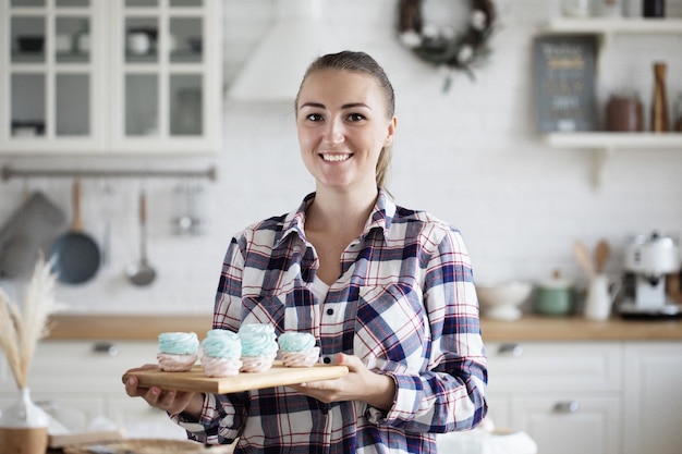 Young baker woman holding pastries Happy smiling and cheerful