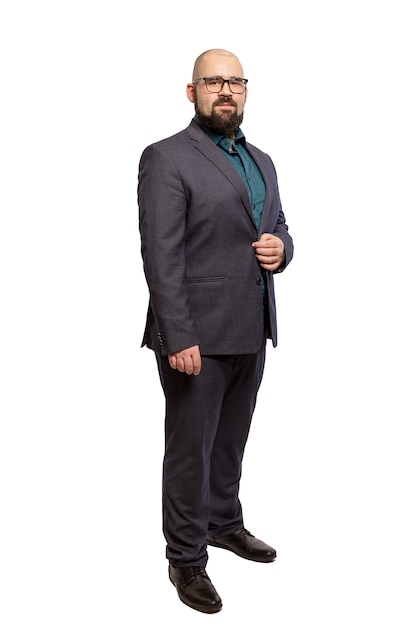 Young bald bearded man with glasses and a full-length suit. Isolated over white background