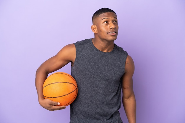 Young basketball latin player man isolated thinking an idea while looking up