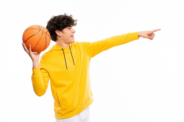 Young basketball player man over isolated white wall