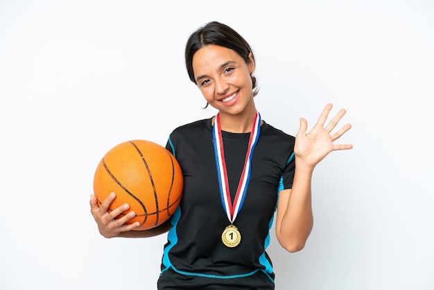 Young basketball player woman isolated on white background counting five with fingers