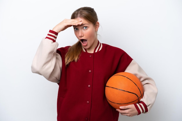 Young basketball player woman isolated on white background doing surprise gesture while looking to the side