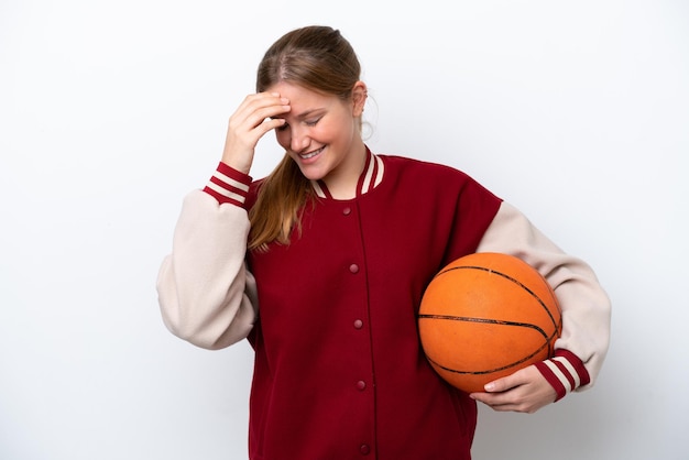 Young basketball player woman isolated on white background laughing