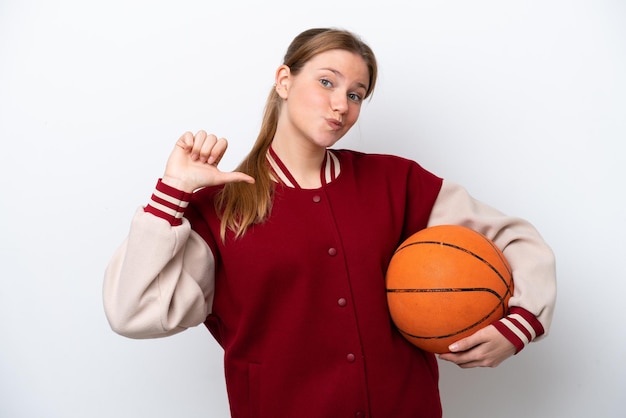 Young basketball player woman isolated on white background proud and selfsatisfied