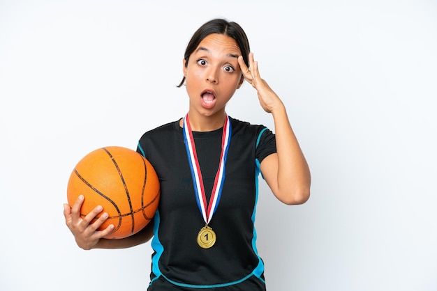 Young basketball player woman isolated on white background with surprise expression