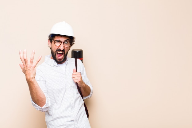 Young  bearded architect man  angry expression