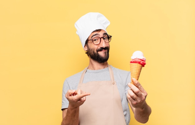 Young bearded chef man happy expression and holding an ice cream